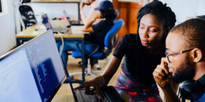 Two colleagues looking at a computer small business